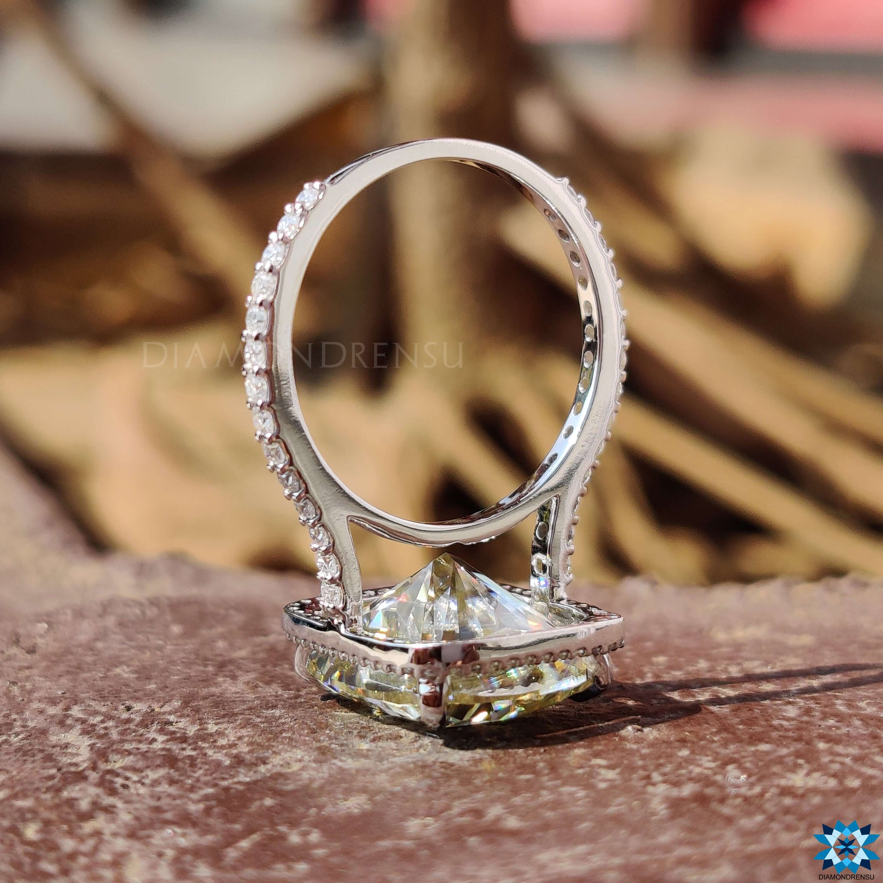 Handmade halo engagement ring with elongated cushion cut.