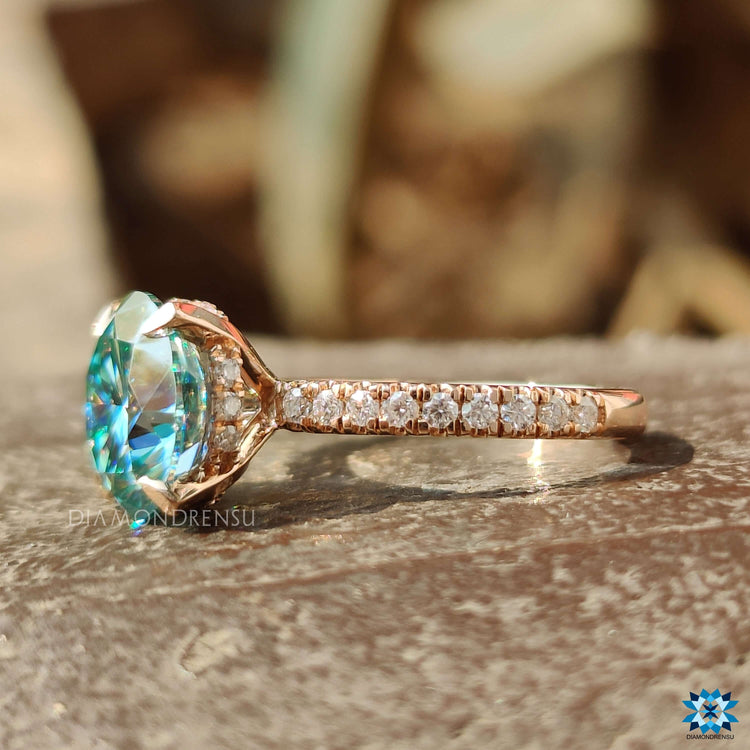 Round cut moissanite ring with pave setting and hidden halo.
