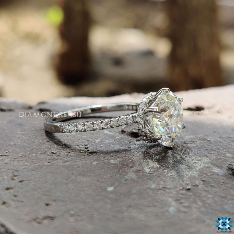 Handmade round moissanite ring with hidden halo design.