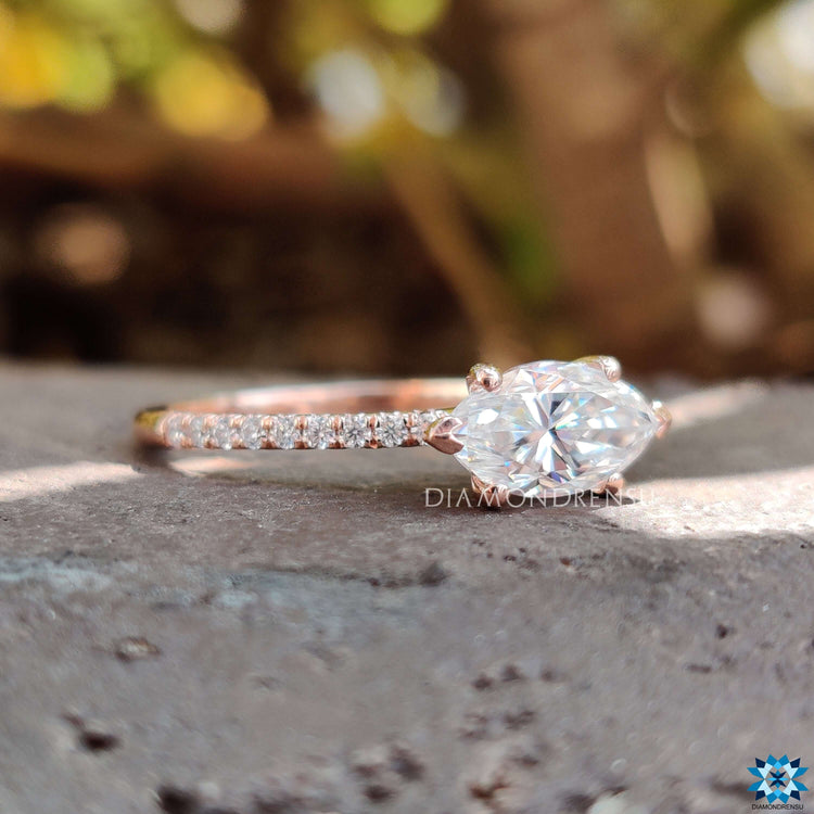 Rose gold engagement ring with marquise center stone.