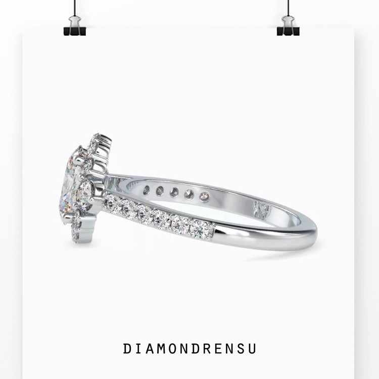 Oval diamond ring with pave setting and round side stones.