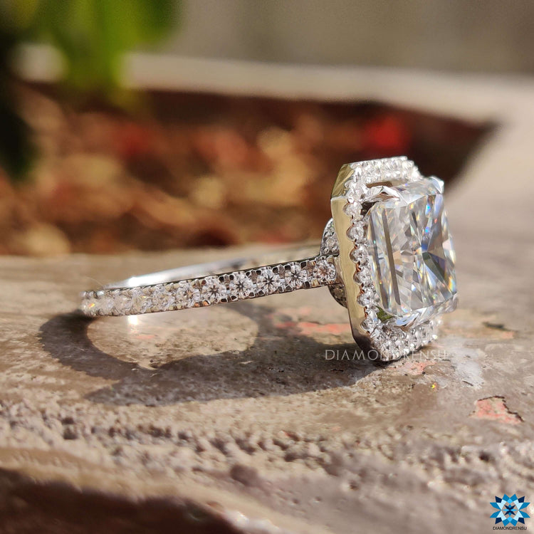 Hidden halo engagement ring with 3/4 pave setting and round side stones.
