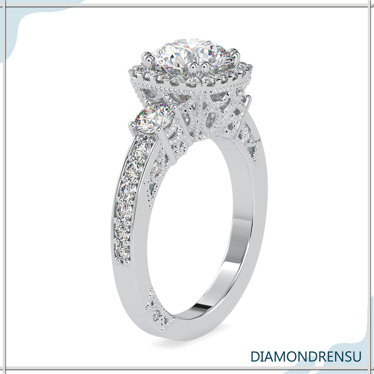 Halo diamond ring with 3 round stones in white gold.