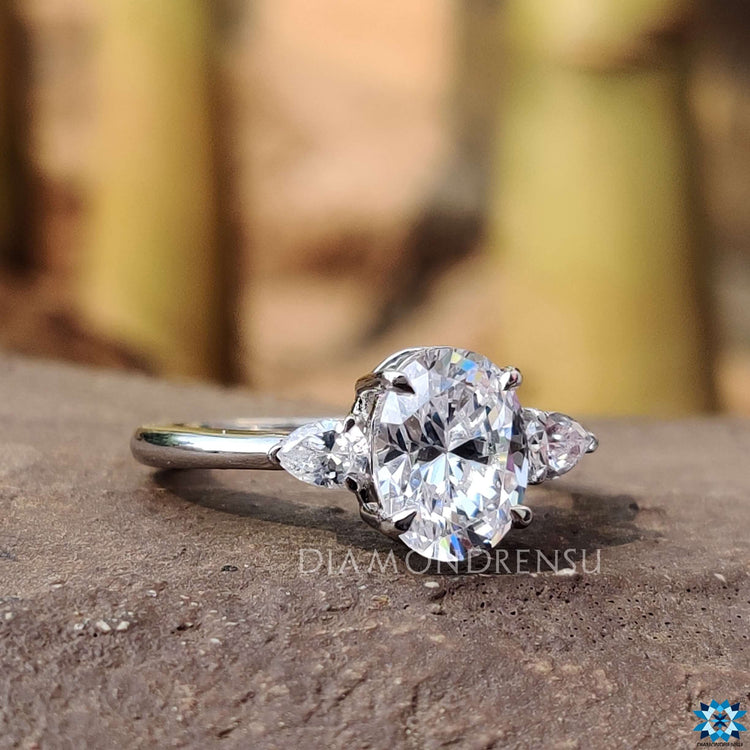 Handmade three stone ring with a 4 claw prong setting.