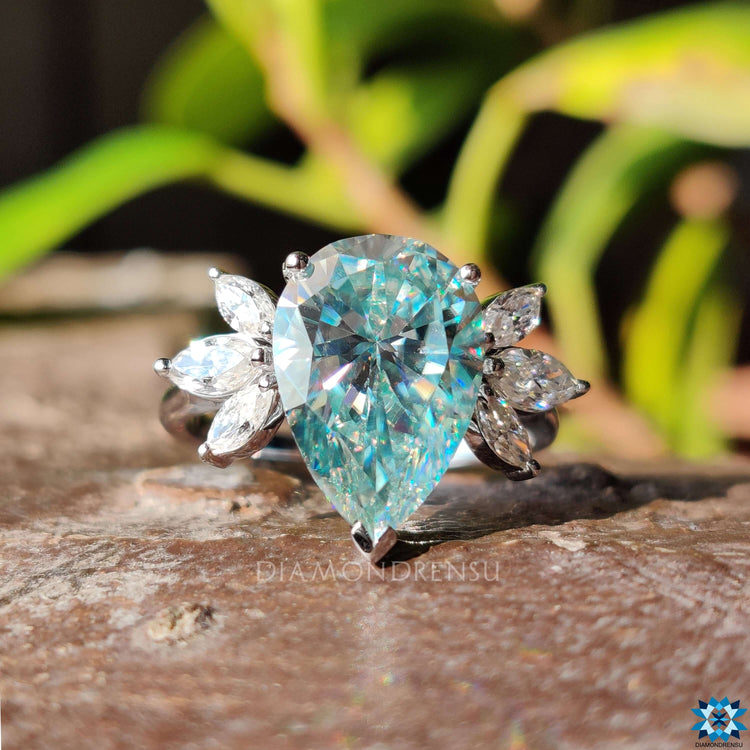 White gold engagement ring with pear moissanite.