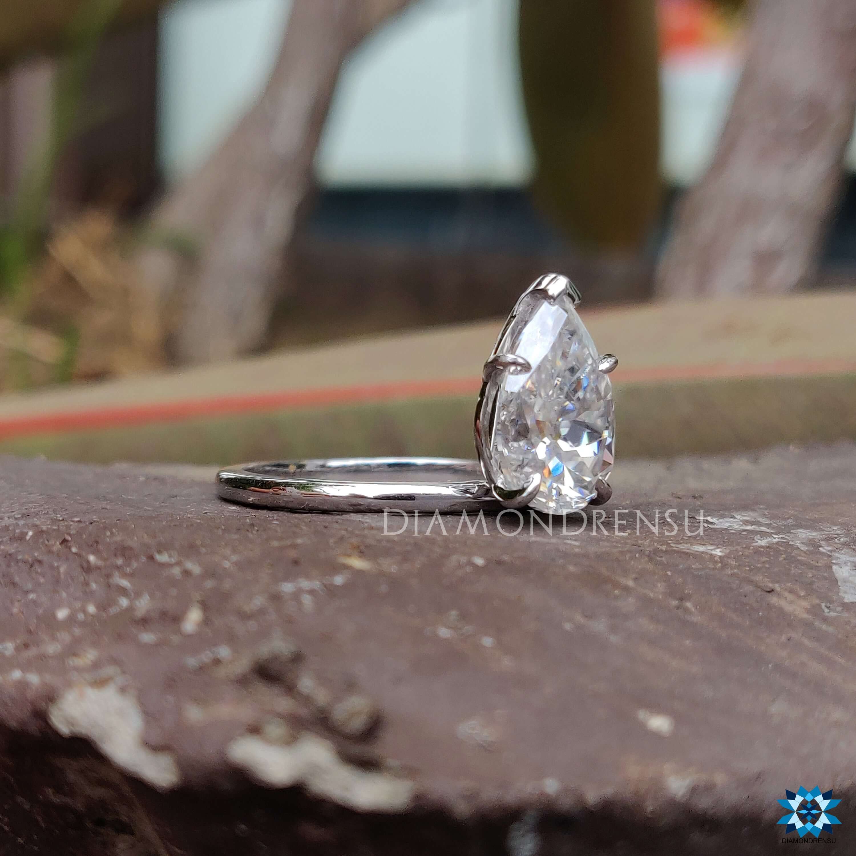 Pear Rensu cut moissanite ring with v shaped prong set in a handmade white gold band.