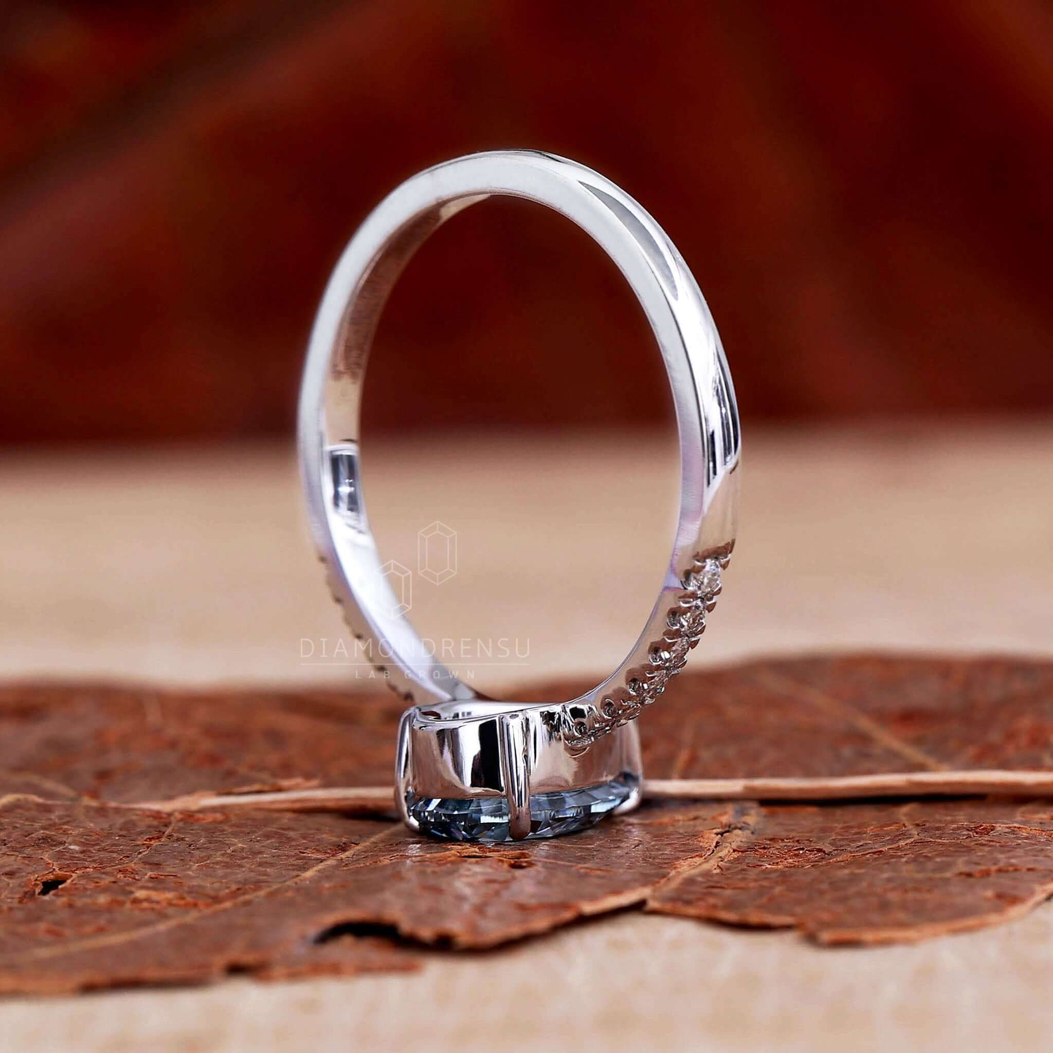 Blue ring featuring a teardrop diamond in a claw prong setting for a modern touch.