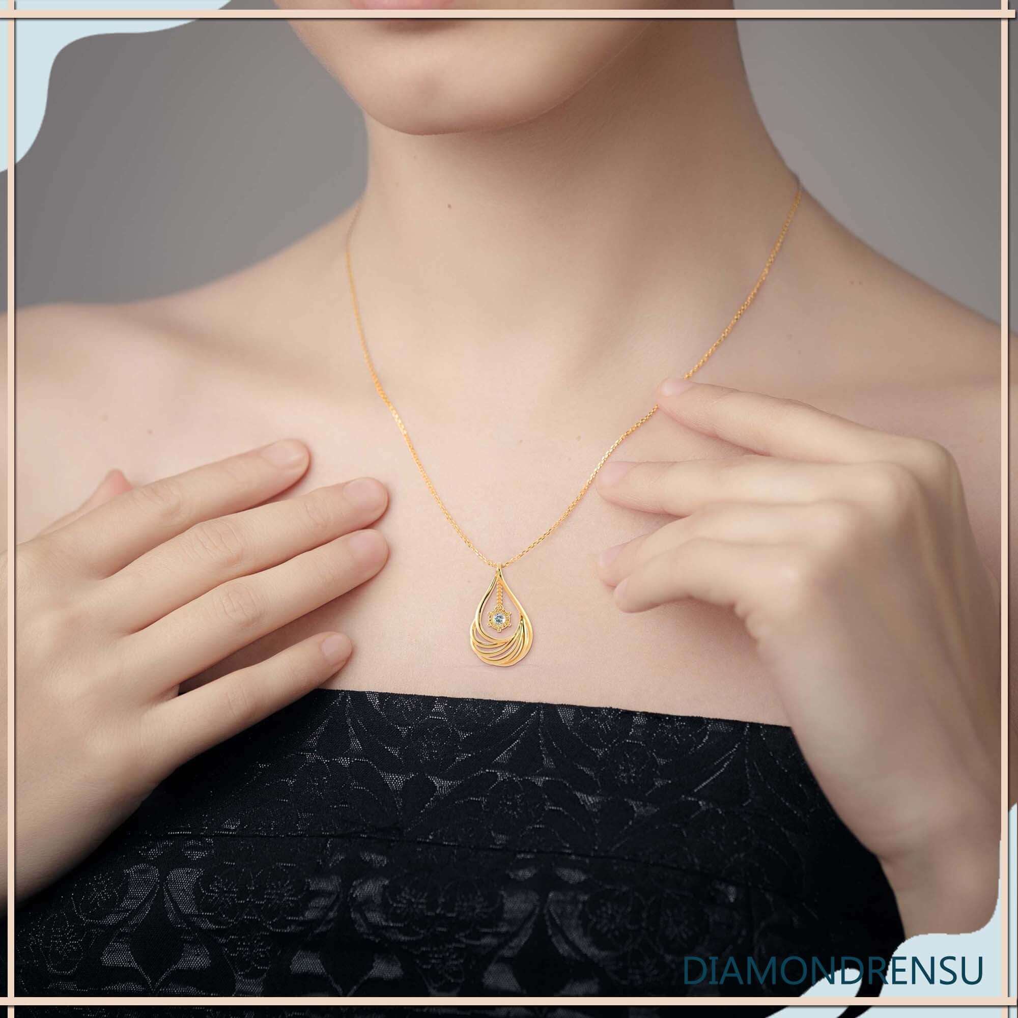 Sunburst halo teardrop pendant in white gold with round diamond.