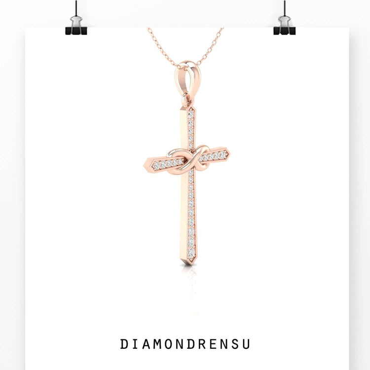 Elegant round diamond pendant in infinity shape with gold setting.
