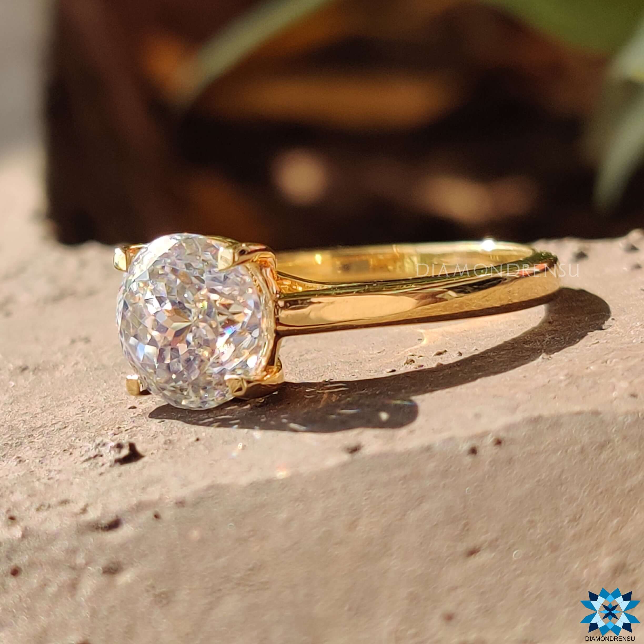 Moissanite solitaire ring in a simple gold band.