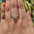 Round halo moissanite ring in a twisted band style.