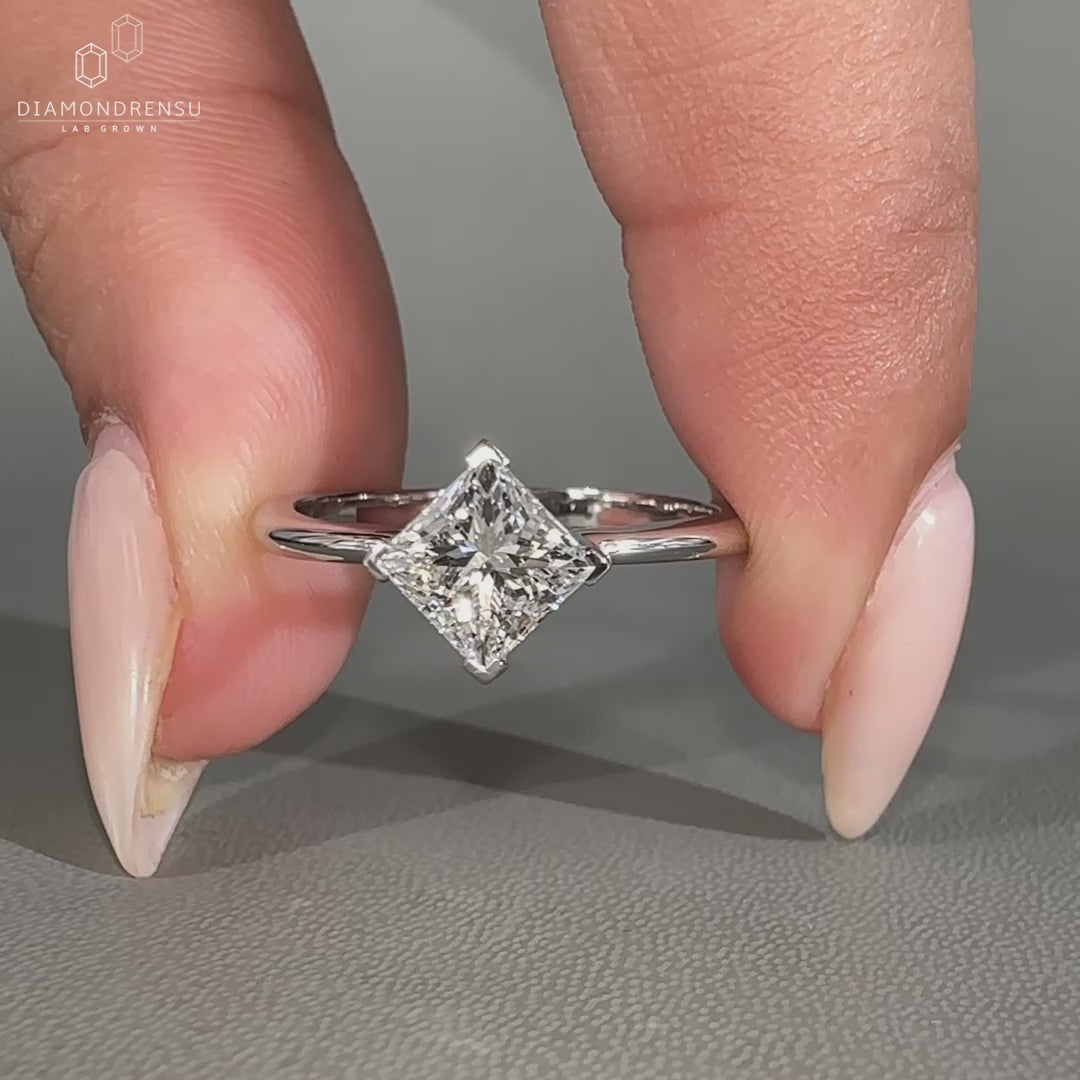 Princess cut ring with 4 V prong setting.