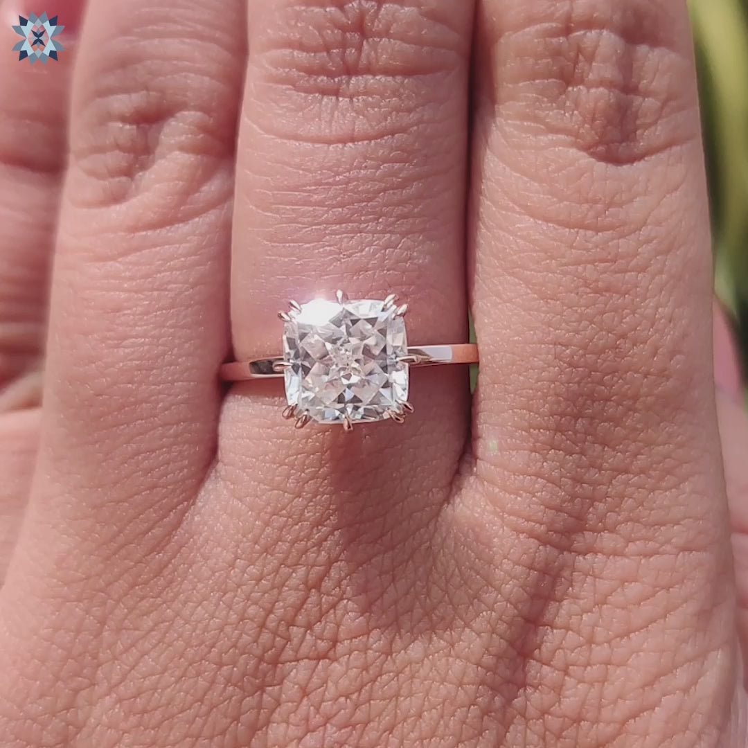 Solitaire ring with double claw prong detail.