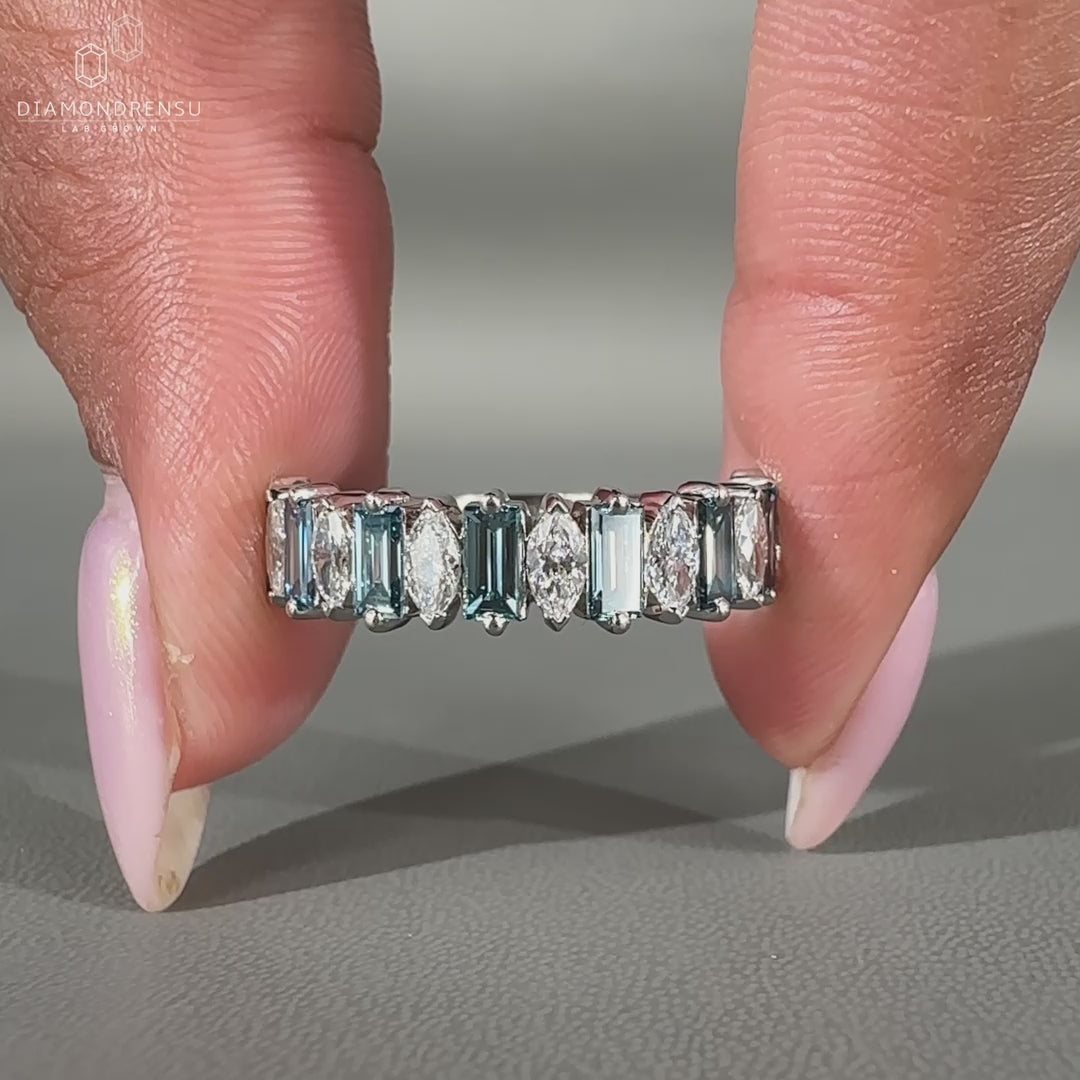 Blue baguette diamond wedding band crafted in white gold with prong setting.