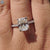 Cushion moissanite ring with secure 4 tab prong setting.