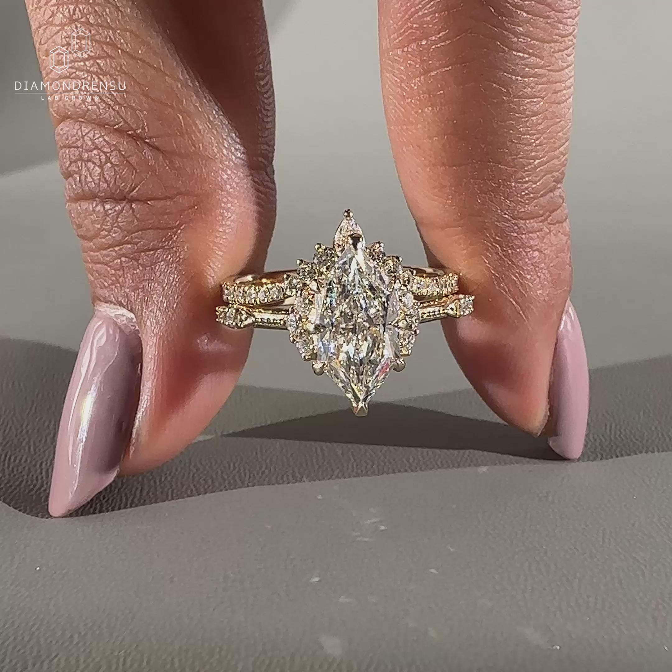 Dutch marquise engagement ring with round side stones and claw prongs.