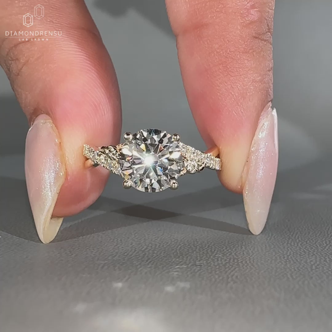 Four prong setting holds the round diamond securely.