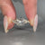 Four prong setting holds the round diamond securely.