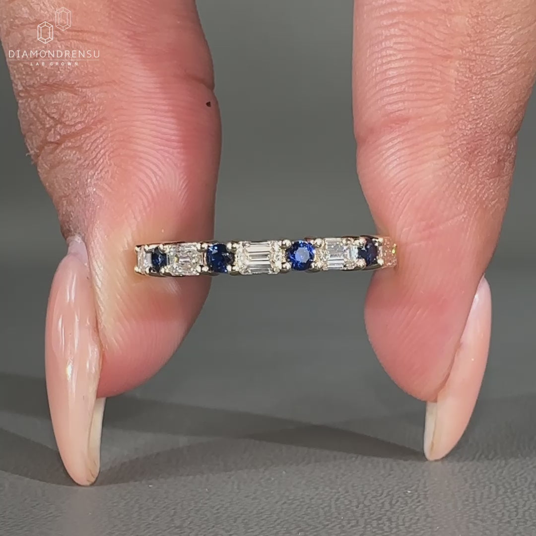 Round cut sapphire band featuring prong set lab grown diamonds.