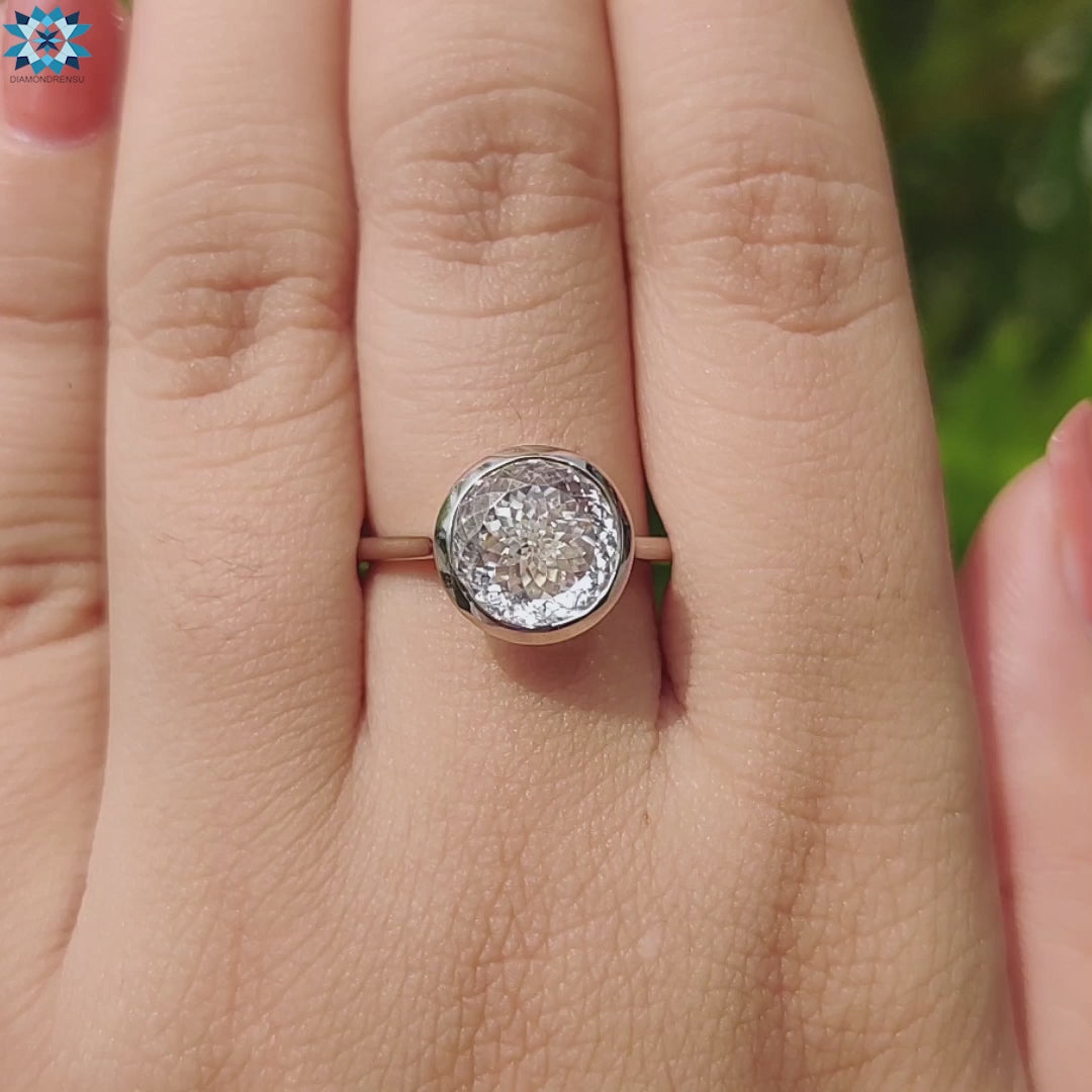 Unique white gold engagement ring with Portuguese cut gem.