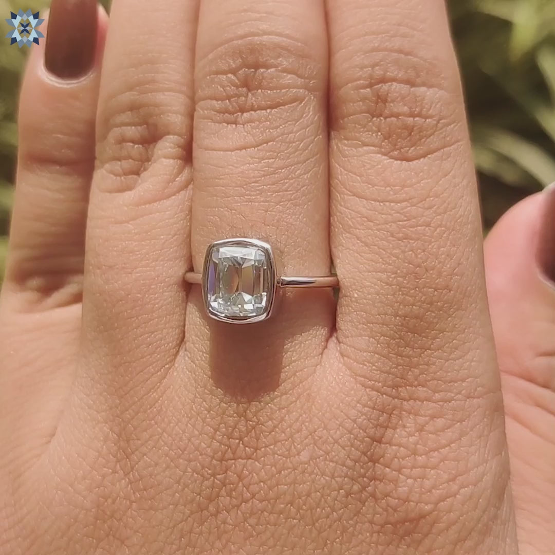 Cushion old European moissanite ring with white gold band.