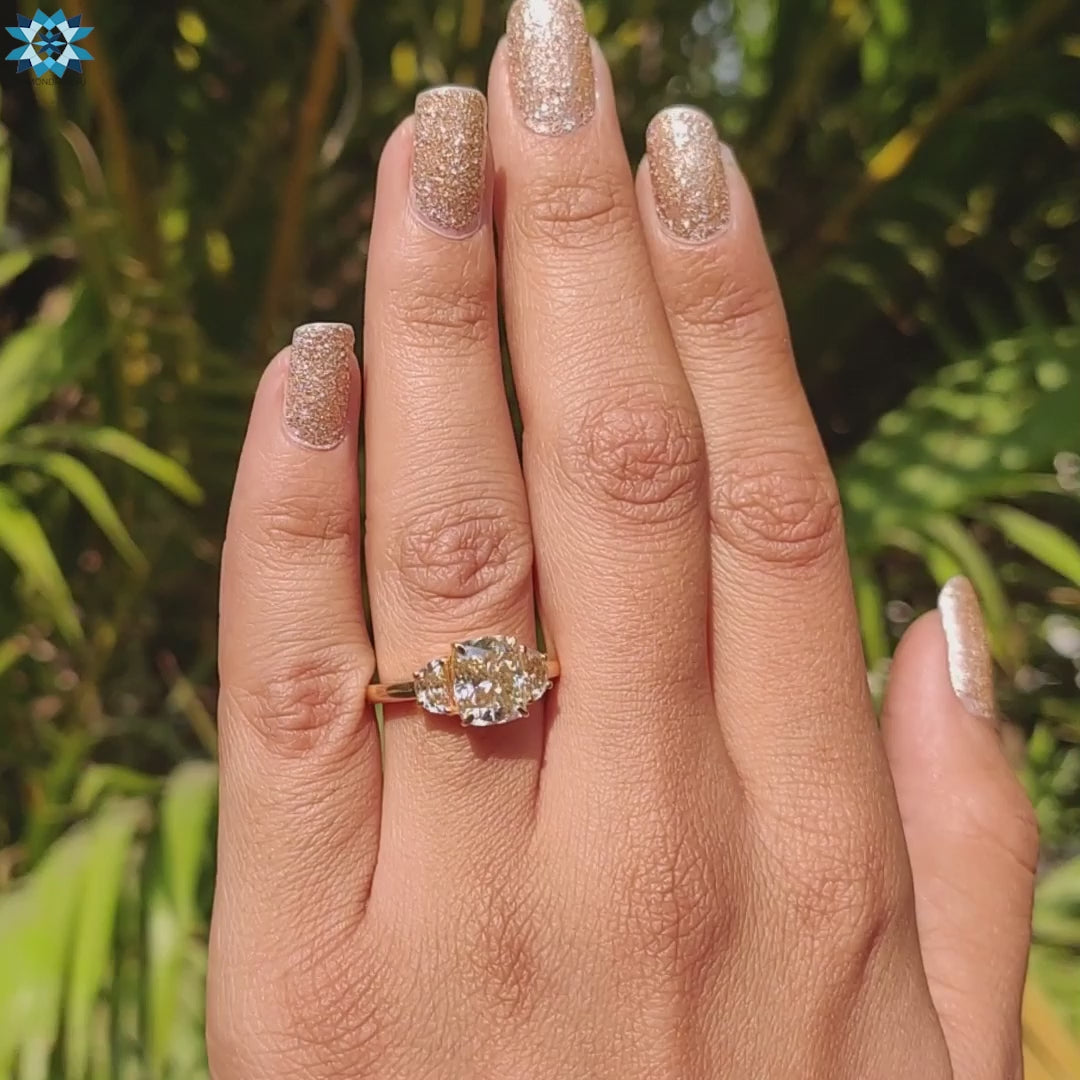 Yellow gold ring with light yellow moissanite stones.