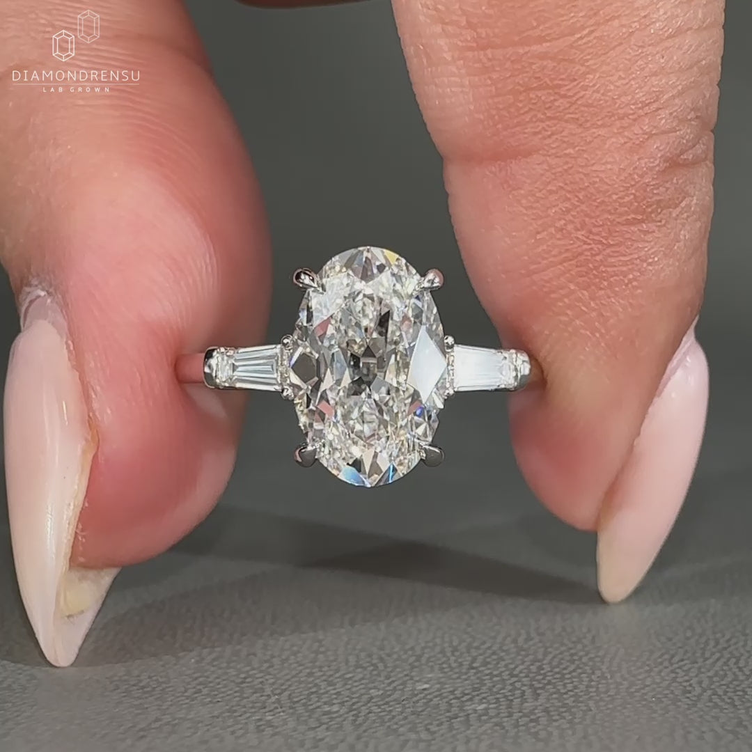 Three stone engagement ring with tapered baguette sides