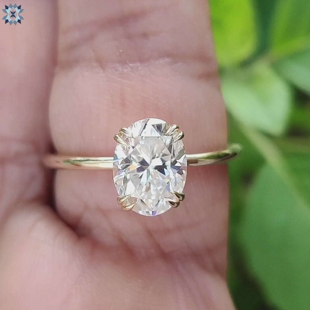 Oval cut moissanite ring with handmade gold setting.