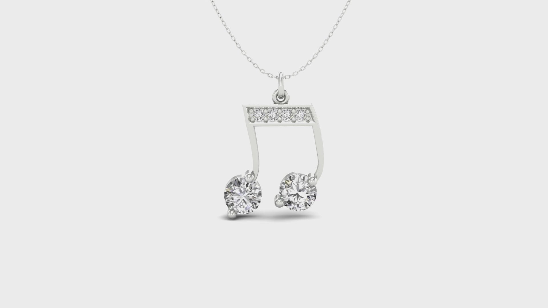 Music note pendant crafted from white and yellow gold.