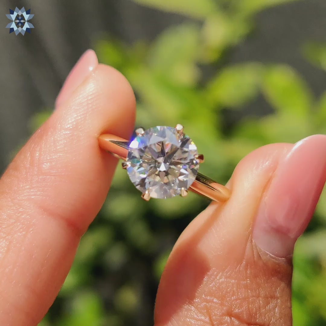 Round cut engagement ring featuring a 6 claw prong setting and elegant solitaire design.