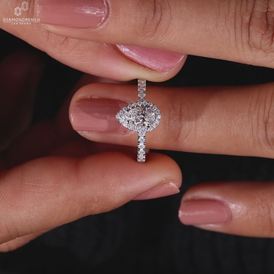 Halo engagement rings with pave diamonds and a pear shaped diamond, perfect as a diamond ring uk gift.