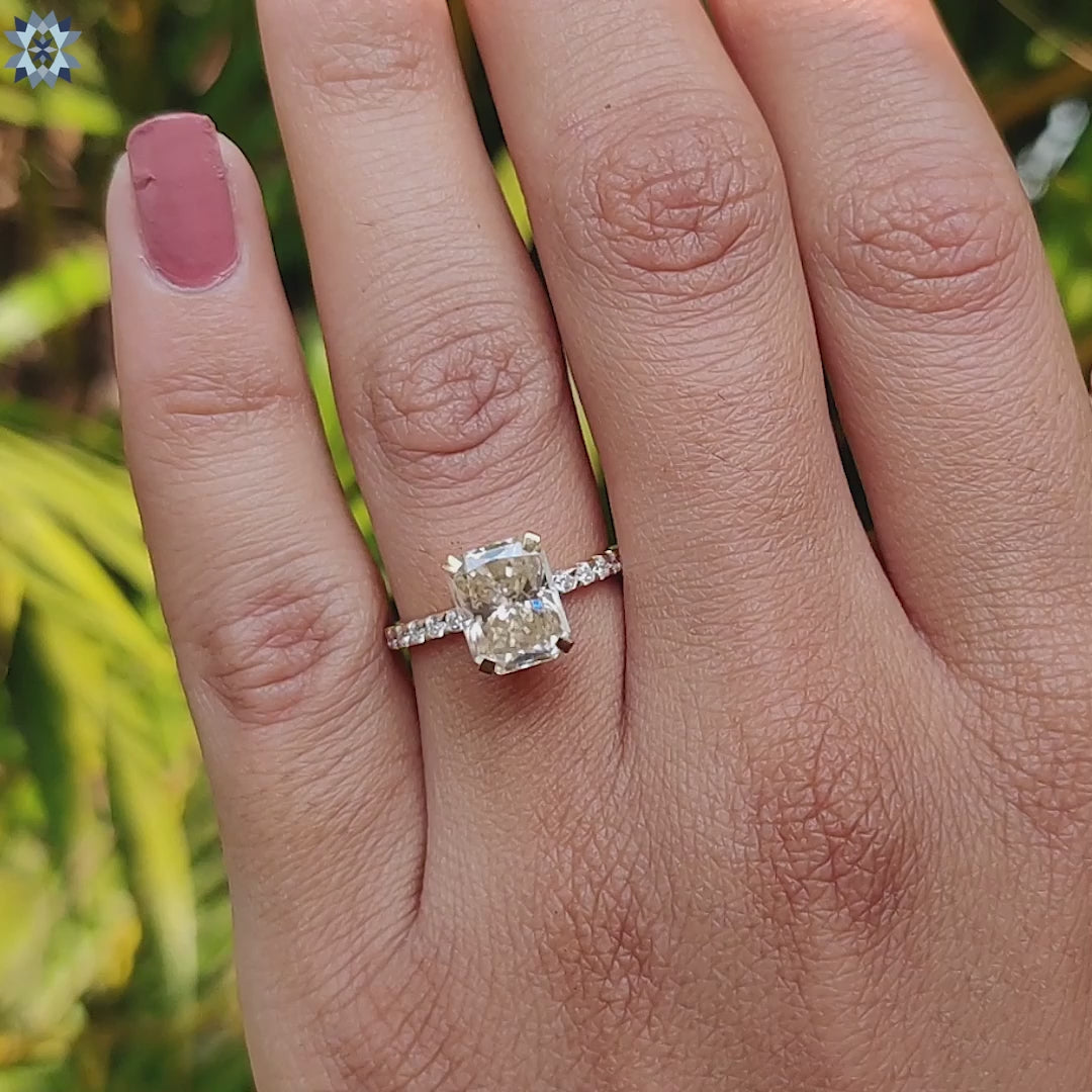 Pave engagement ring with light yellow moissanite center.