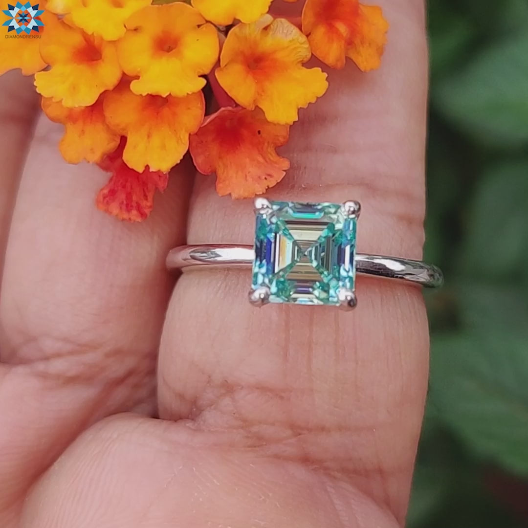 Cyan blue moissanite ring set in a white gold band.