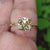Yellow gold ring with old European cushion moissanite.