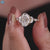 Shared prong engagement ring with oval Rensu moissanite center stone.