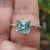 Asscher cut solitaire ring with moissanite in white gold.