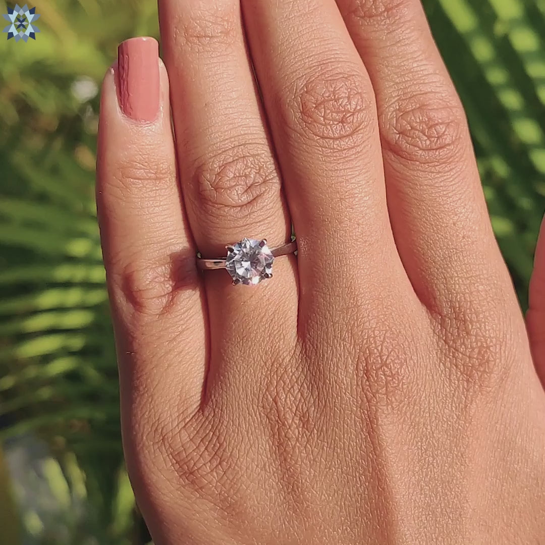 Moissanite engagement ring with minimal design and hidden symbol.