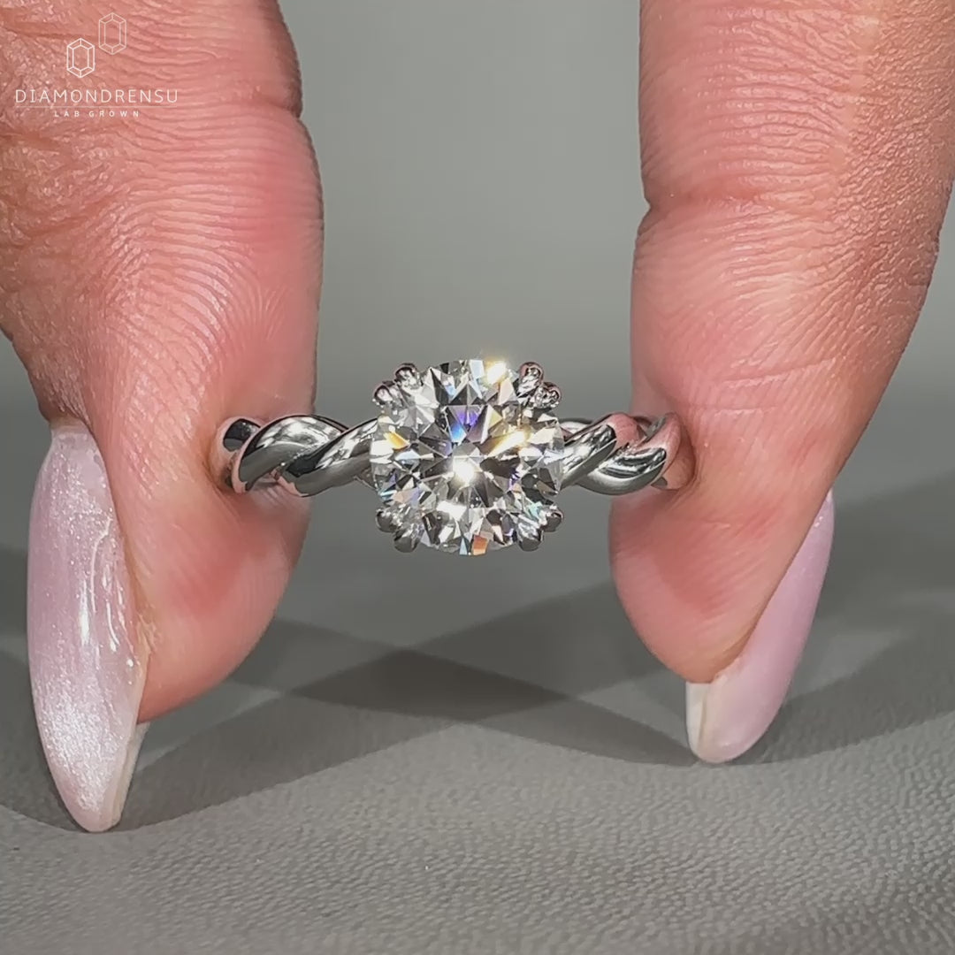 Hidden halo engagement ring with round cut center.
