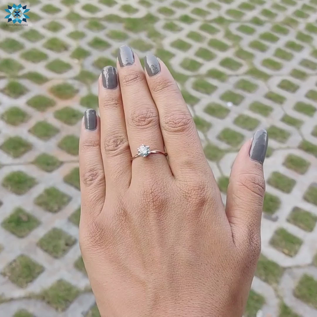Handmade solitaire ring with rose gold and moissanite.