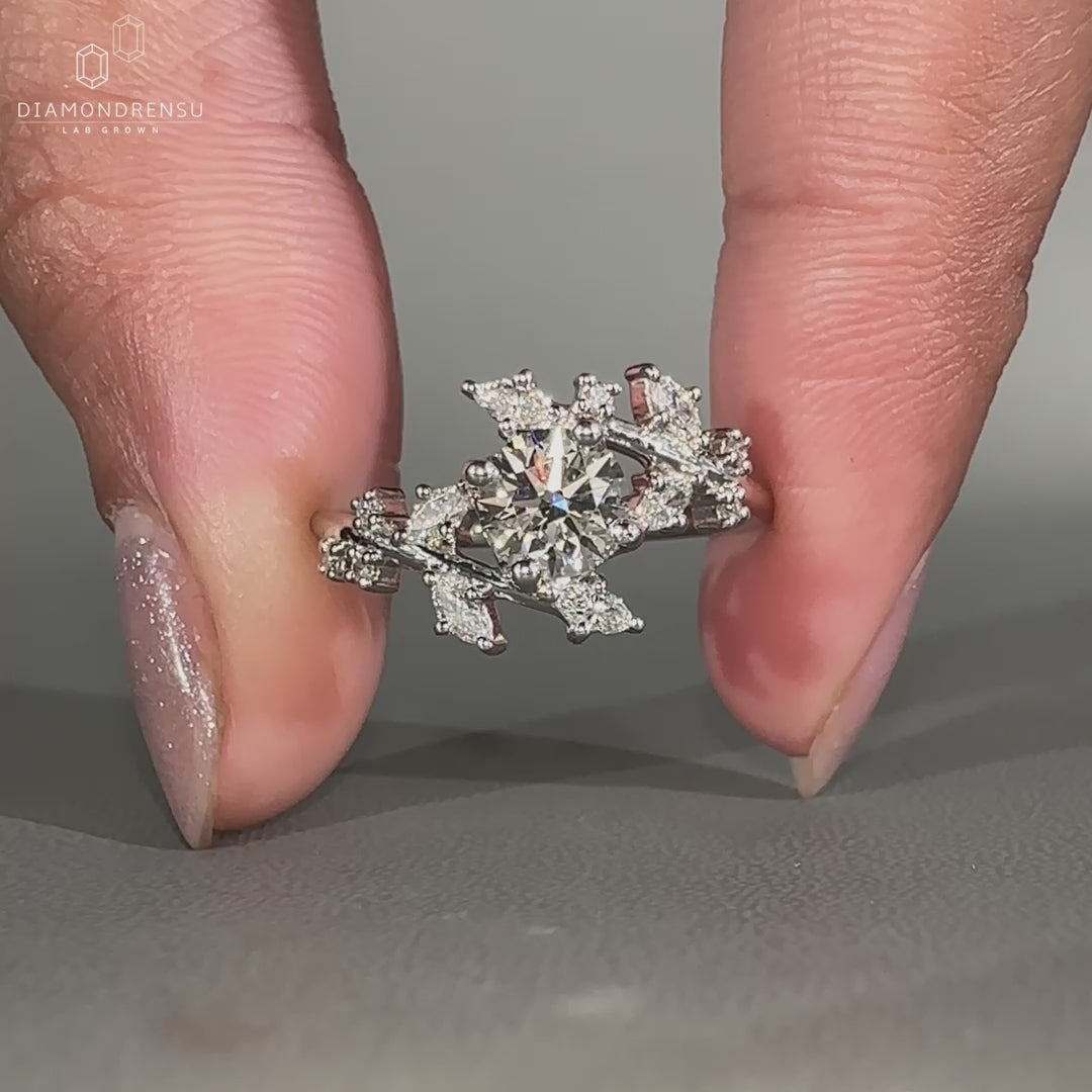 Round cut diamond ring in a cluster setting.