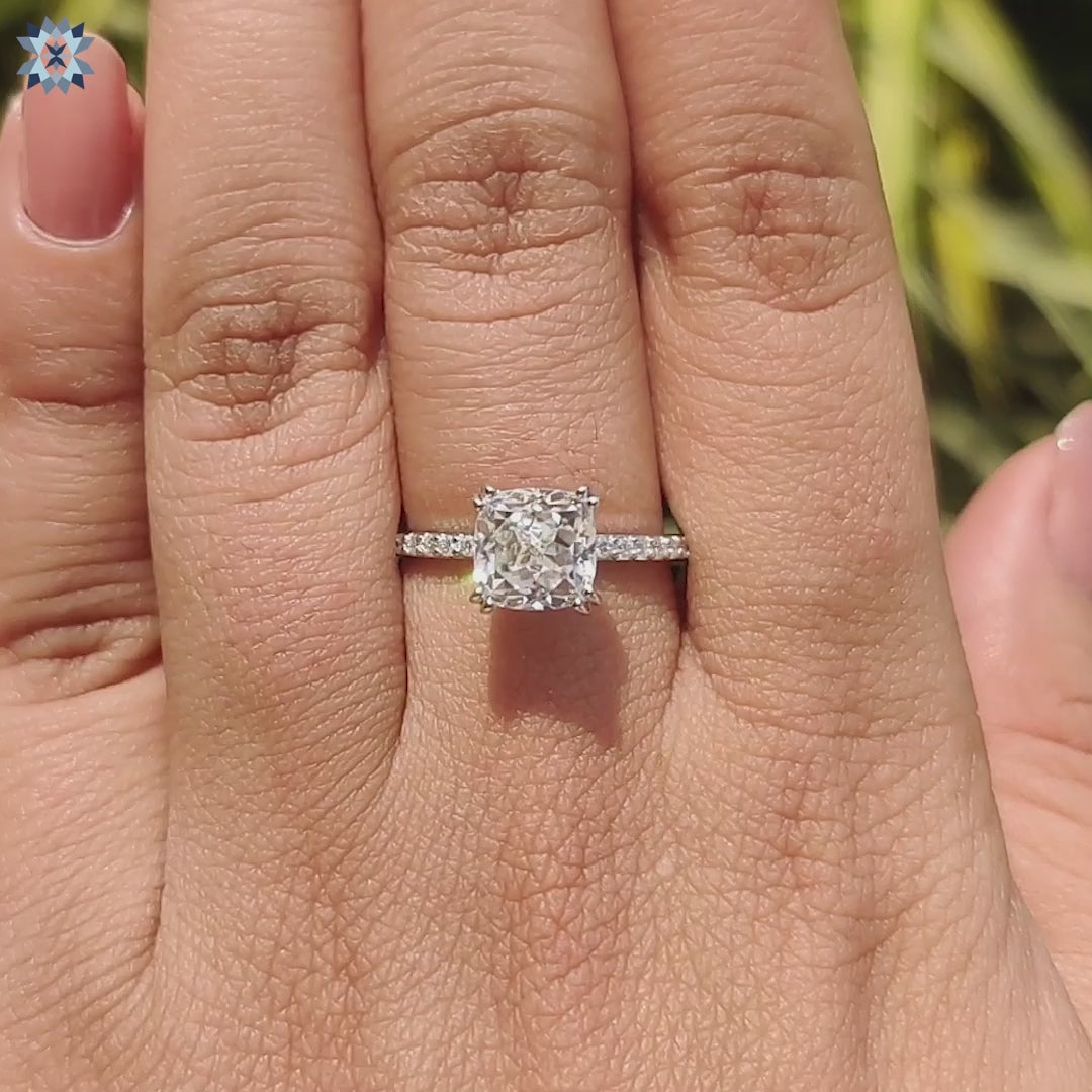 Custom engagement ring with hidden halo and pave accents.