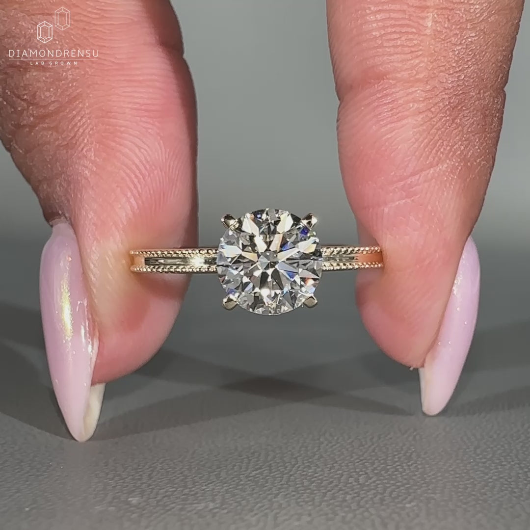 Round diamond ring with four tab prong setting