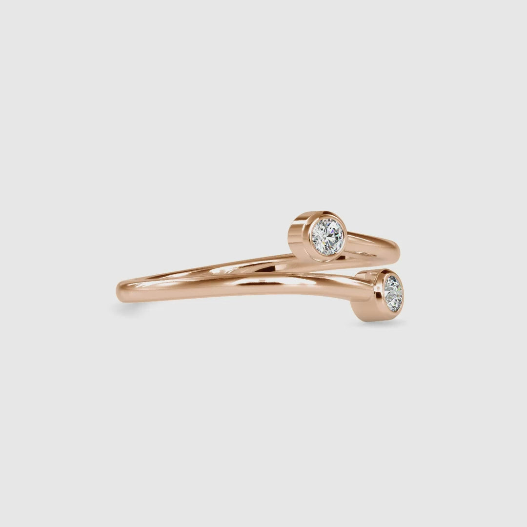 Round diamond bezel wedding band in rose gold finish.