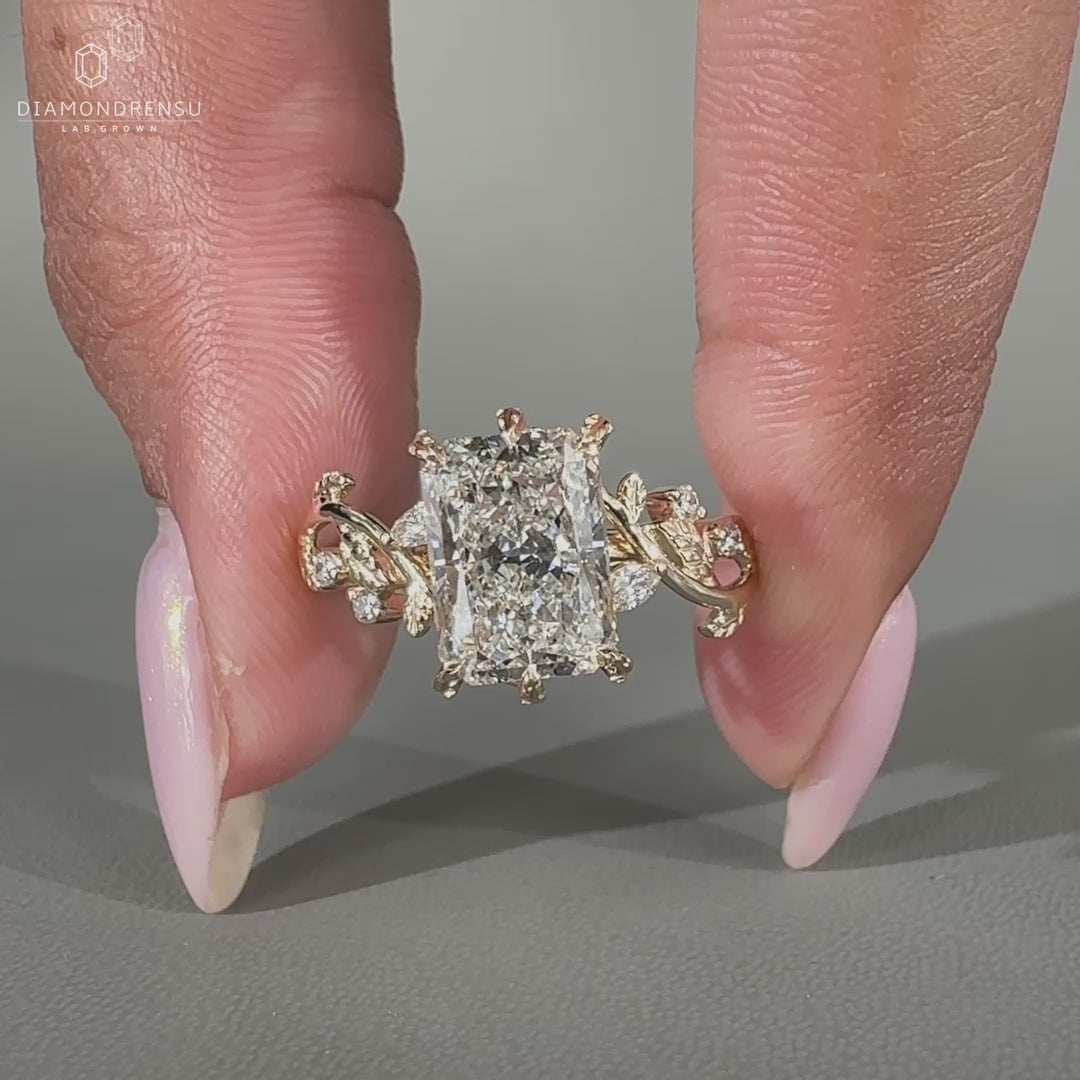 Nature inspired ring with marquise and round side stones