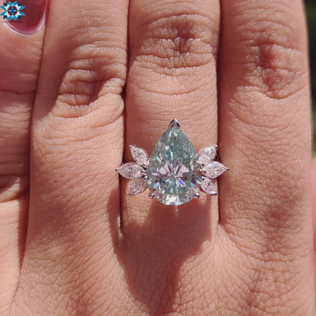 Marquise side stone ring with pear center.