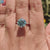 Diamondrensu UK ring featuring a round moissanite in solitaire mount.