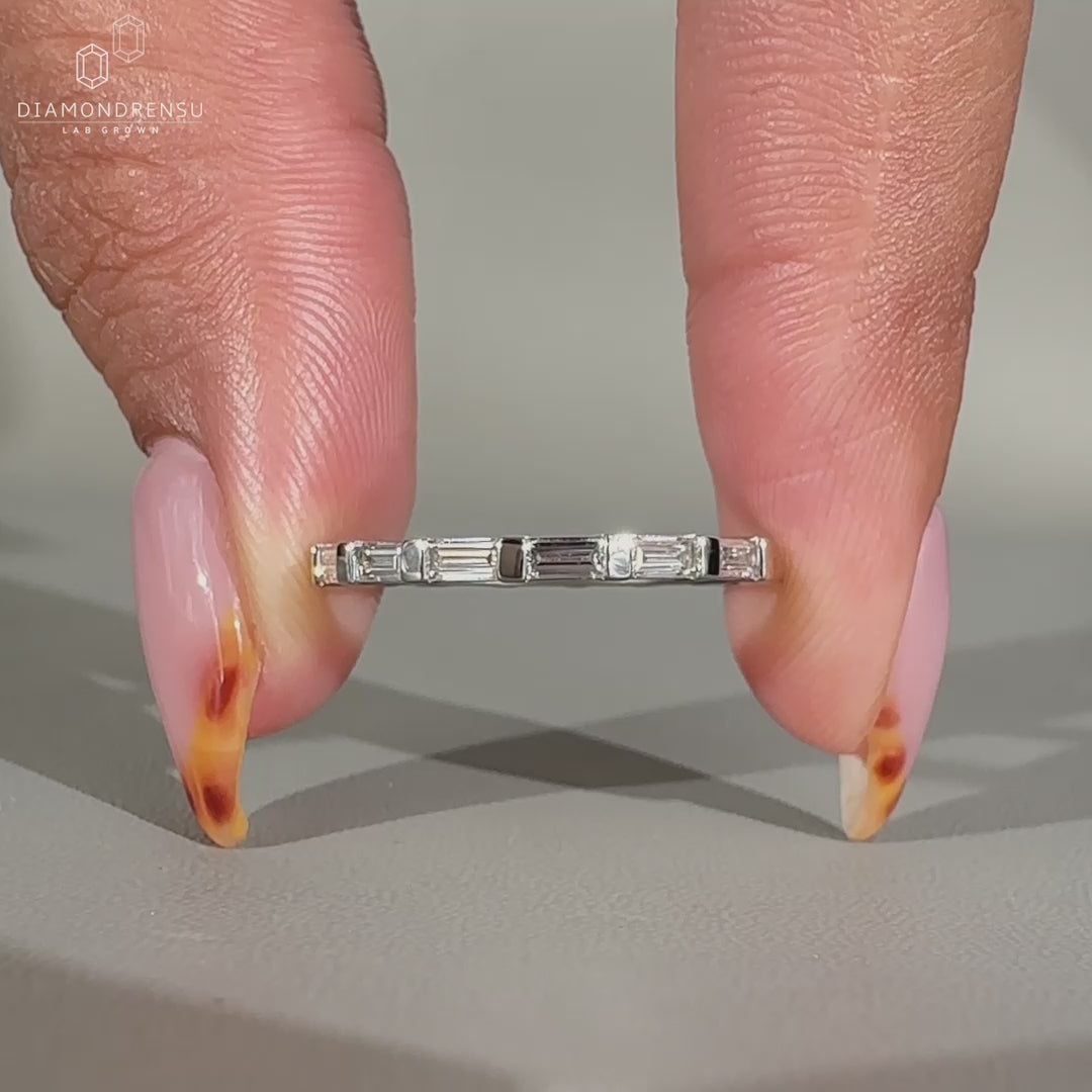 Full eternity diamond band featuring bar set baguette cut diamonds.