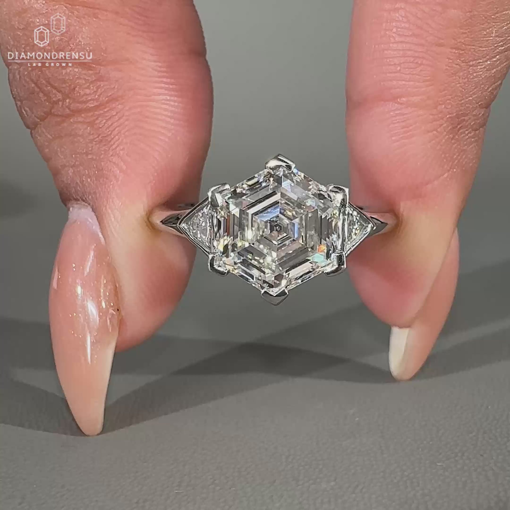 Three stone engagement ring with hexagon and triangle diamonds