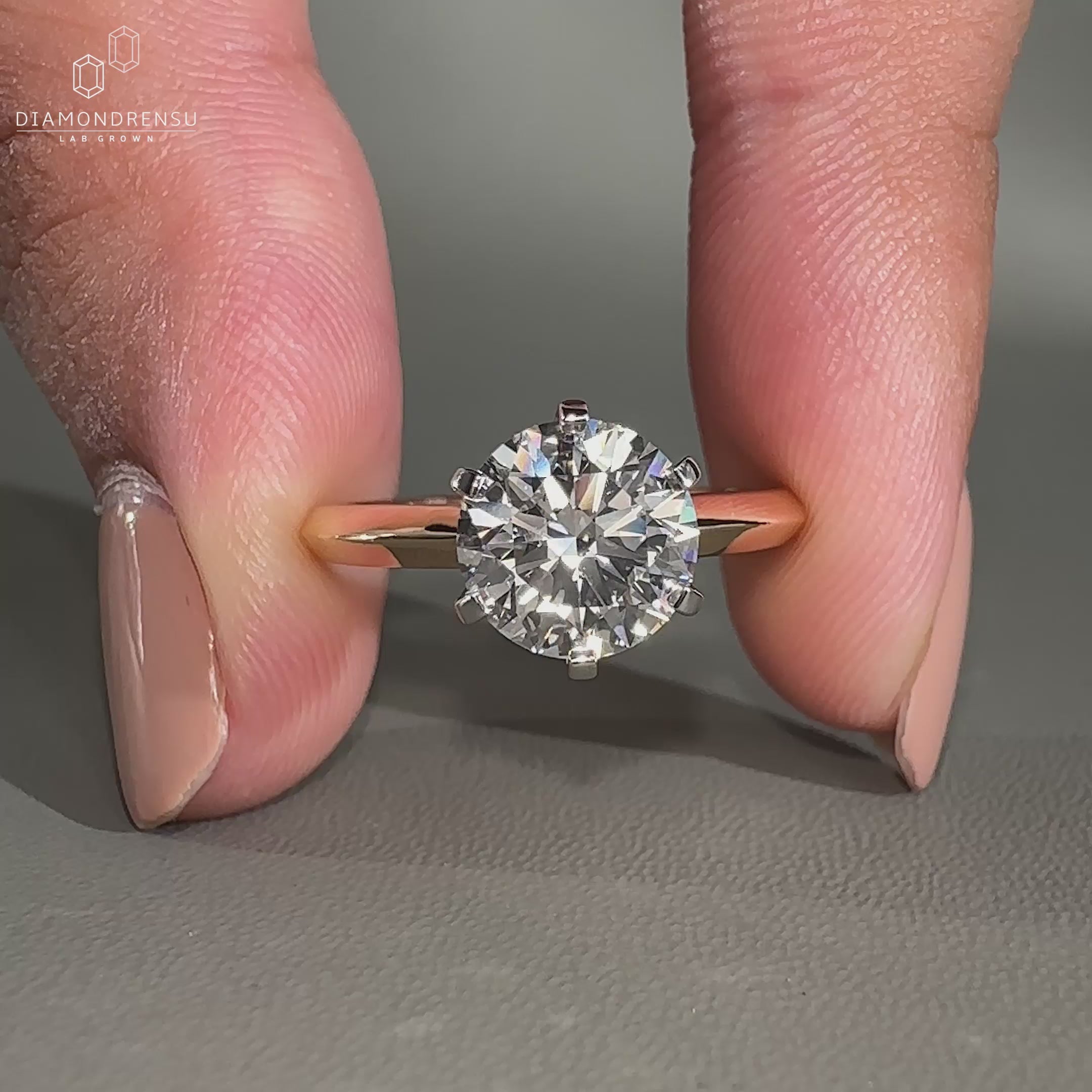 Round cut engagement ring in white and yellow gold design.