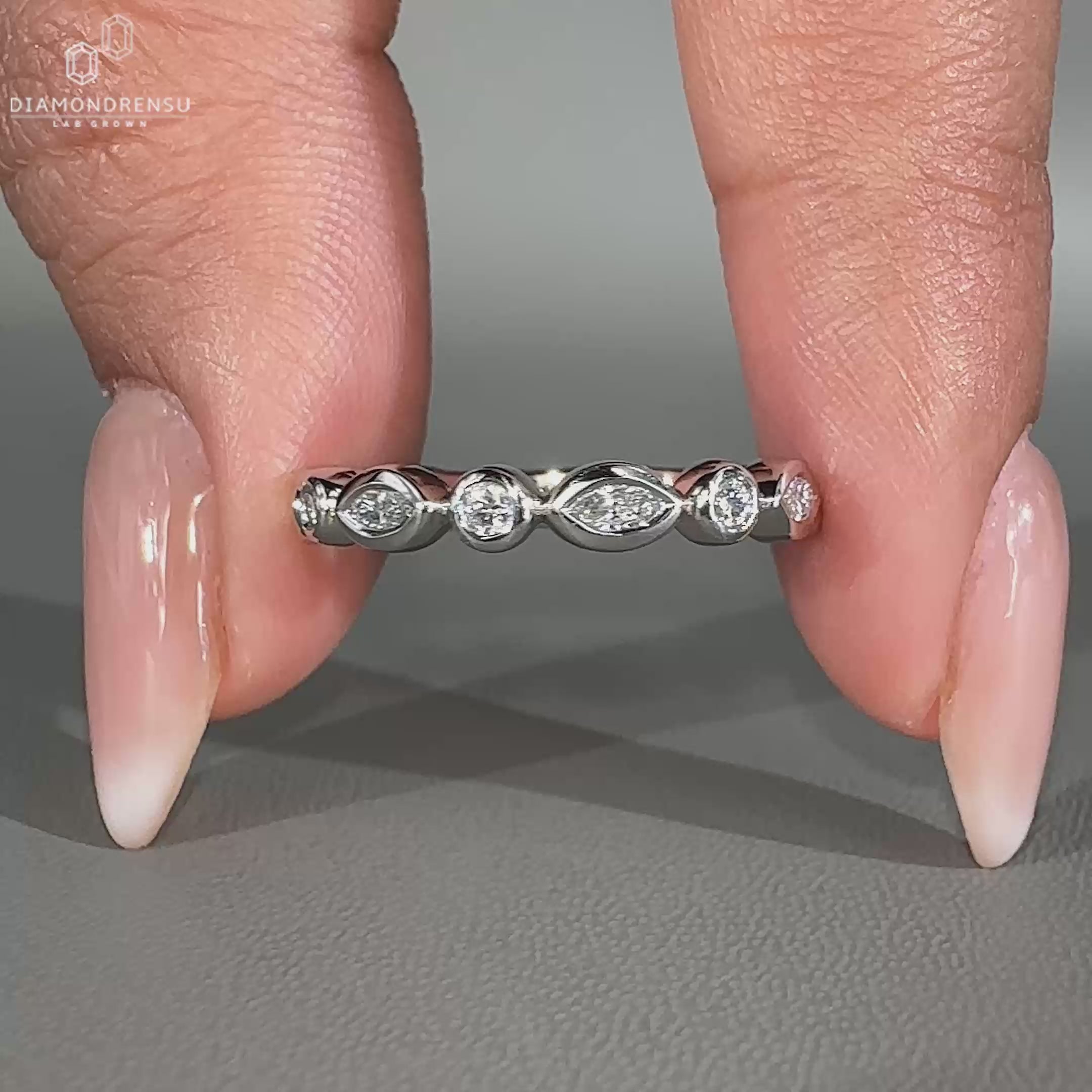 Marquise and round diamond band with a sleek bezel setting.